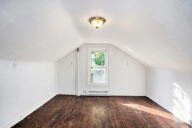 additional living space featuring a textured ceiling, baseboard heating, vaulted ceiling, and dark hardwood / wood-style flooring