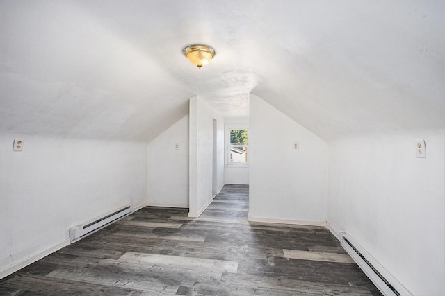 additional living space featuring dark wood-type flooring, lofted ceiling, and baseboard heating