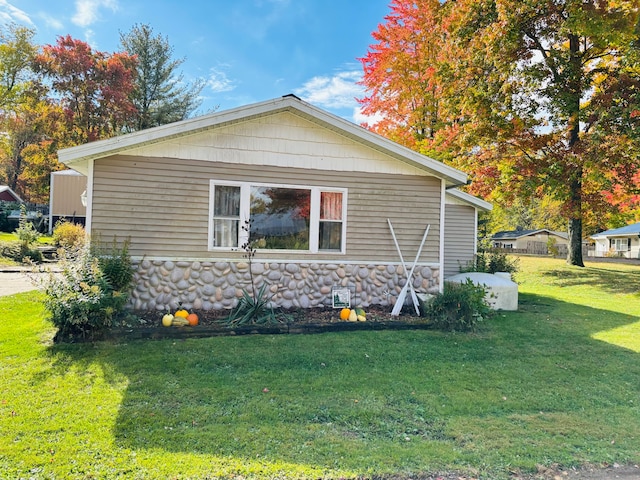 view of home's exterior with a yard