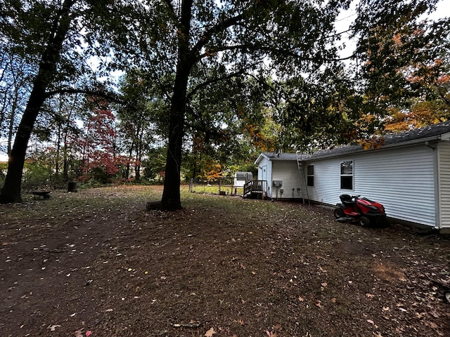 view of yard with a wooden deck