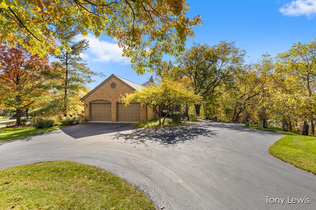 view of front of home featuring a front yard and a garage