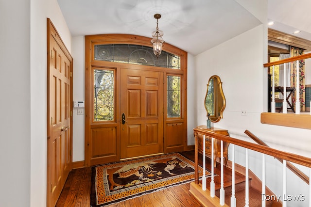 entrance foyer featuring vaulted ceiling and dark hardwood / wood-style flooring