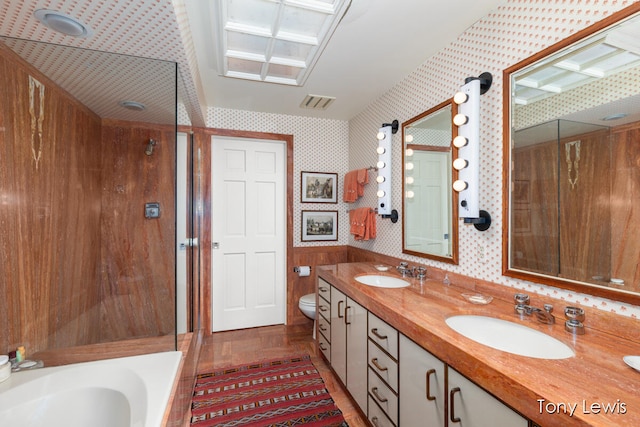 full bathroom with vanity, toilet, plus walk in shower, and hardwood / wood-style floors