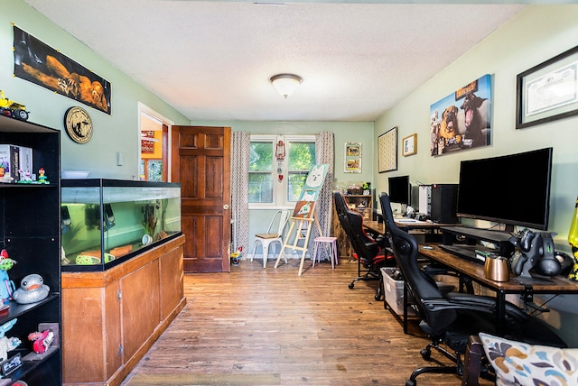 office area featuring a textured ceiling and light hardwood / wood-style floors