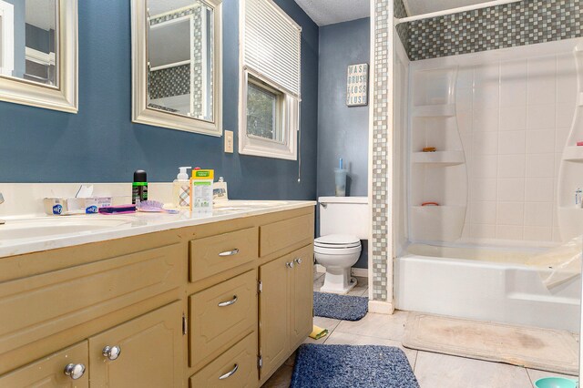 full bathroom featuring tile patterned floors, toilet, washtub / shower combination, and vanity