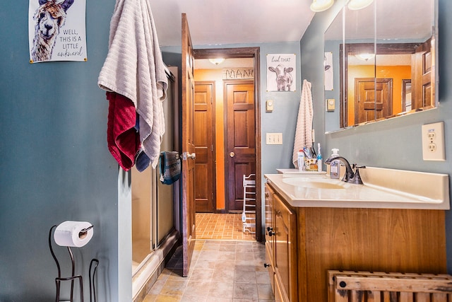 bathroom featuring walk in shower and vanity