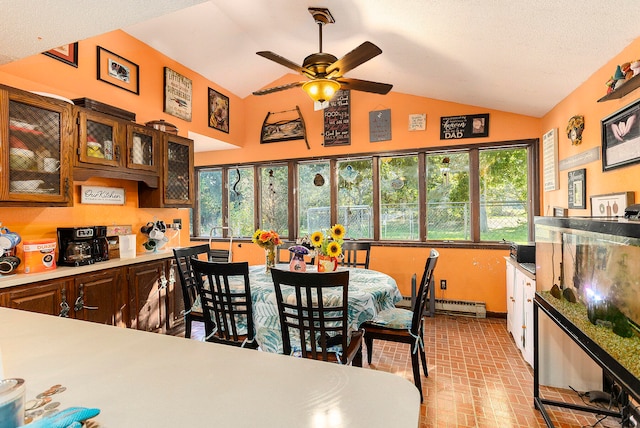 dining space with ceiling fan, a textured ceiling, lofted ceiling, and baseboard heating