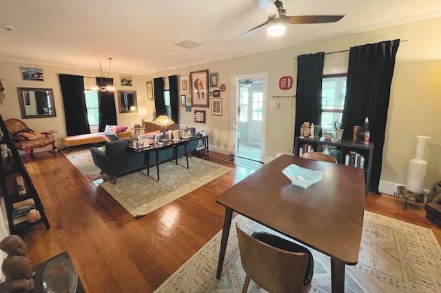 dining room featuring ceiling fan, hardwood / wood-style flooring, crown molding, and plenty of natural light