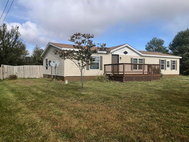 back of property featuring a wooden deck and a yard