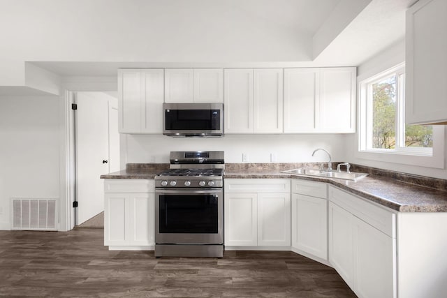 kitchen featuring appliances with stainless steel finishes, sink, and white cabinetry