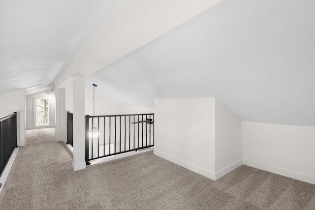 bonus room featuring lofted ceiling and carpet