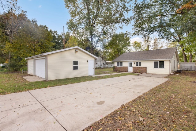 rear view of property featuring an outdoor structure and a garage