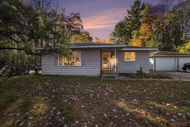 ranch-style house with a yard and a garage