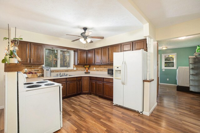 kitchen with dark wood-type flooring, tasteful backsplash, a textured ceiling, white appliances, and ceiling fan