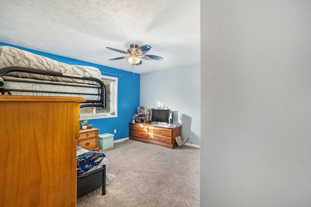 carpeted bedroom with a textured ceiling and ceiling fan