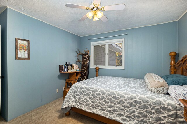 bedroom featuring a textured ceiling, carpet flooring, and ceiling fan