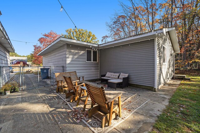 back of property featuring a patio and an outdoor living space