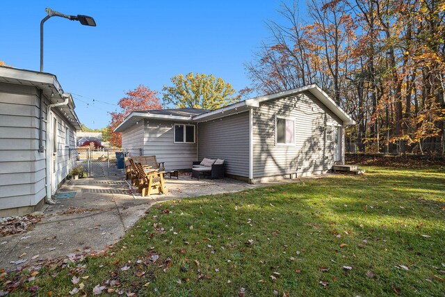 rear view of house with a yard and a patio