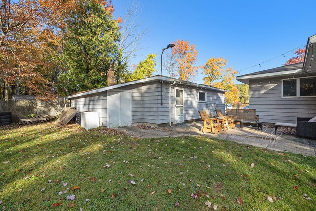 back of property featuring a patio and a lawn