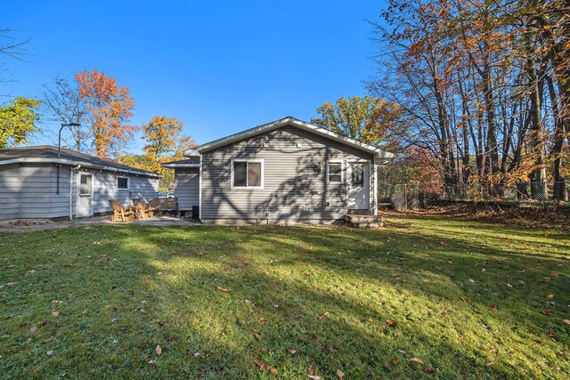 back of house with a lawn