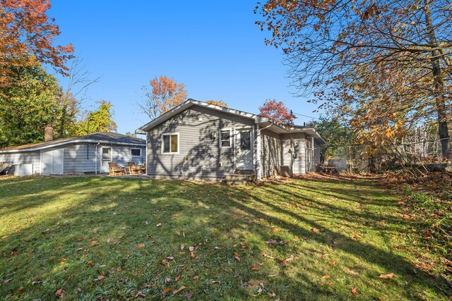 rear view of house featuring a lawn