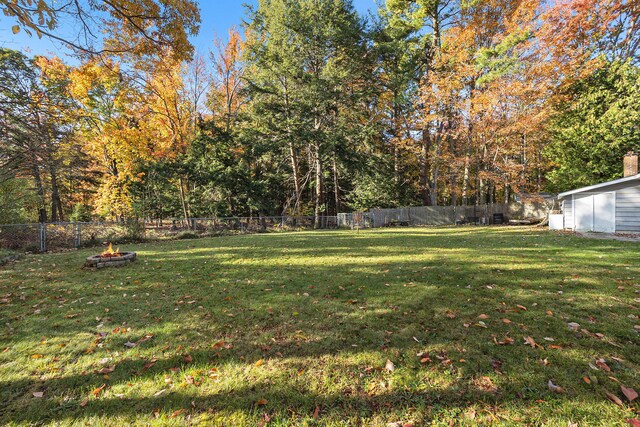 view of yard with an outdoor fire pit