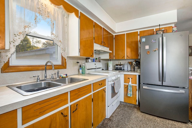 kitchen with stainless steel fridge, sink, and white range