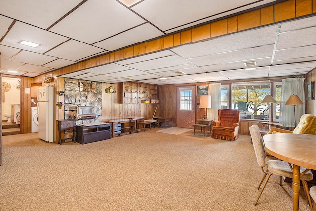 living room with wooden walls and carpet flooring