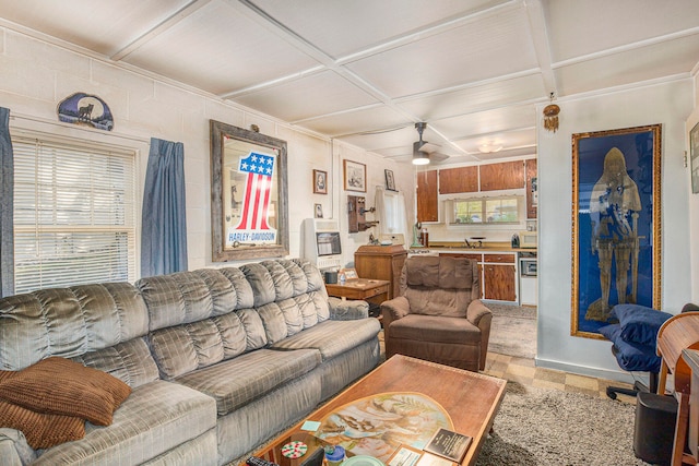 living room with ceiling fan and coffered ceiling