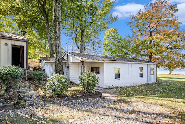 view of front of home with a storage shed