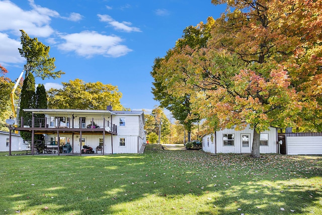 exterior space featuring a lawn and a balcony