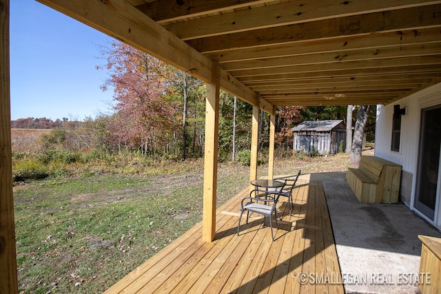 wooden deck with a patio area and a shed