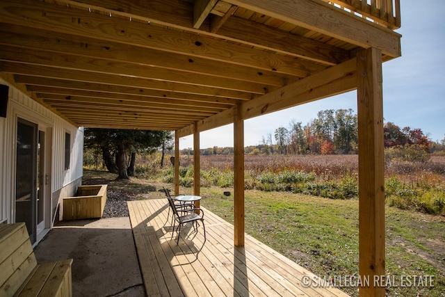 wooden deck featuring a rural view