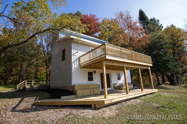 rear view of house with a wooden deck