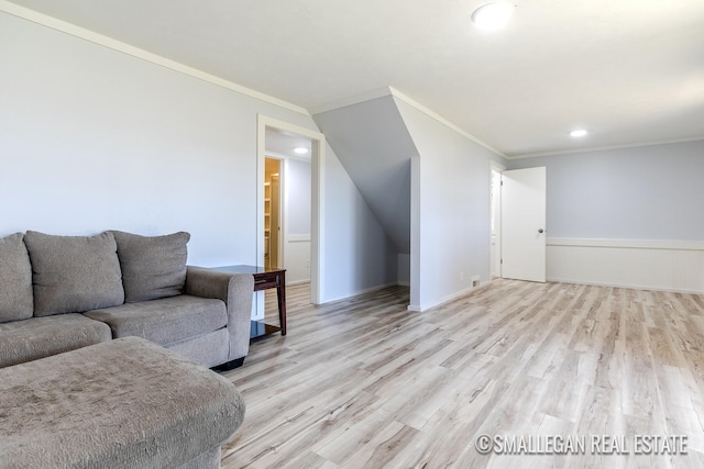 living room with ornamental molding and light hardwood / wood-style flooring