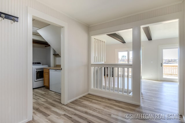 hall with washer / dryer, beam ceiling, and light hardwood / wood-style floors