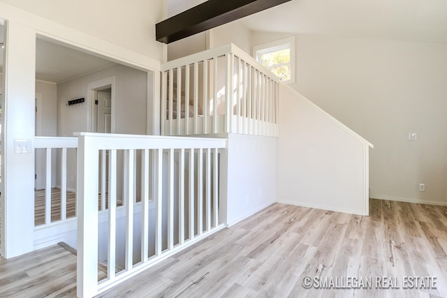 staircase with lofted ceiling and hardwood / wood-style floors