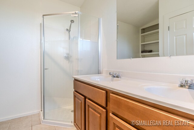 bathroom with vanity, an enclosed shower, and tile patterned floors