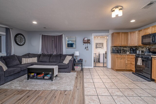 living room featuring light tile patterned flooring and a textured ceiling