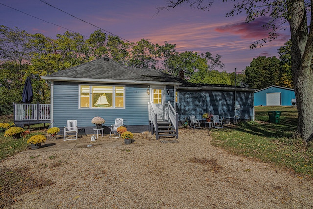 view of front of house with an outbuilding and a deck