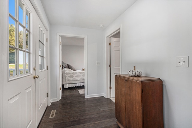 corridor with dark hardwood / wood-style floors