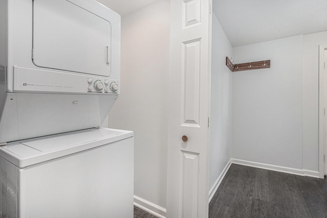 laundry room with stacked washer and clothes dryer and dark hardwood / wood-style floors