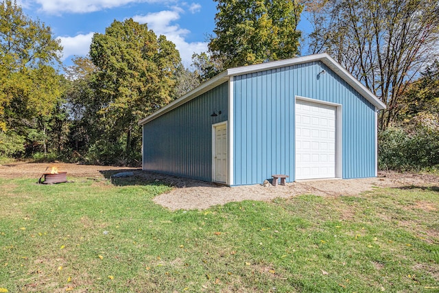 view of outbuilding featuring a lawn and a garage