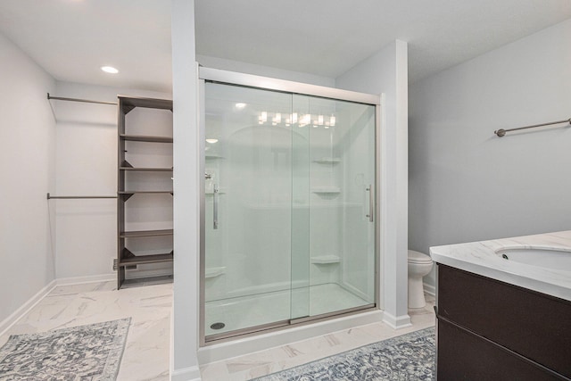 bathroom with vanity, toilet, and a shower with door