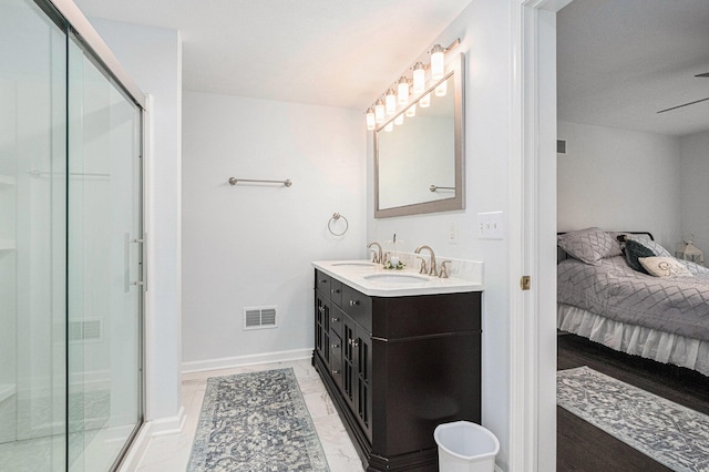 bathroom with a shower with door and vanity