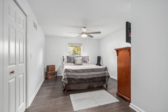 bedroom with ceiling fan, a closet, and dark wood-type flooring