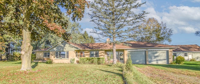 ranch-style home featuring a garage and a front lawn