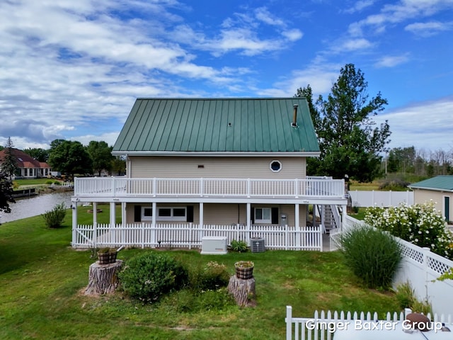 back of property featuring a yard, central AC, and a deck