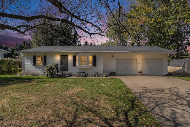 ranch-style home with a yard and a garage