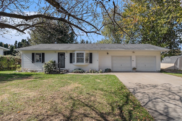 ranch-style home featuring a garage and a front lawn